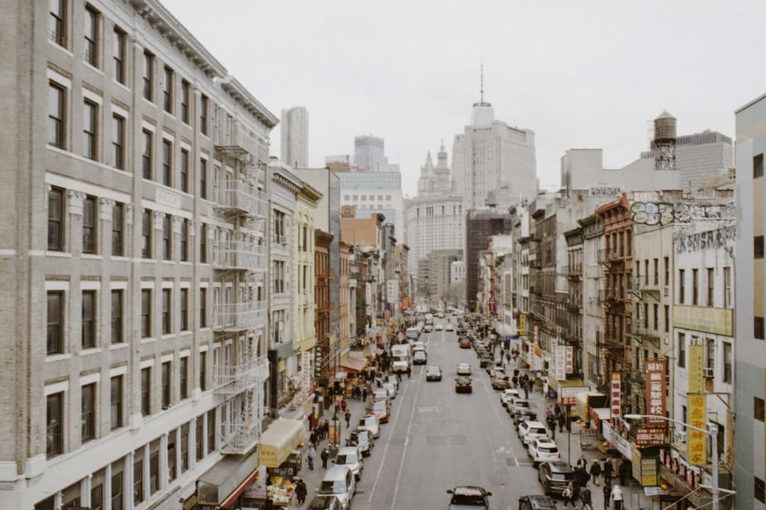 Traffic moving through a dense Chinatown street
