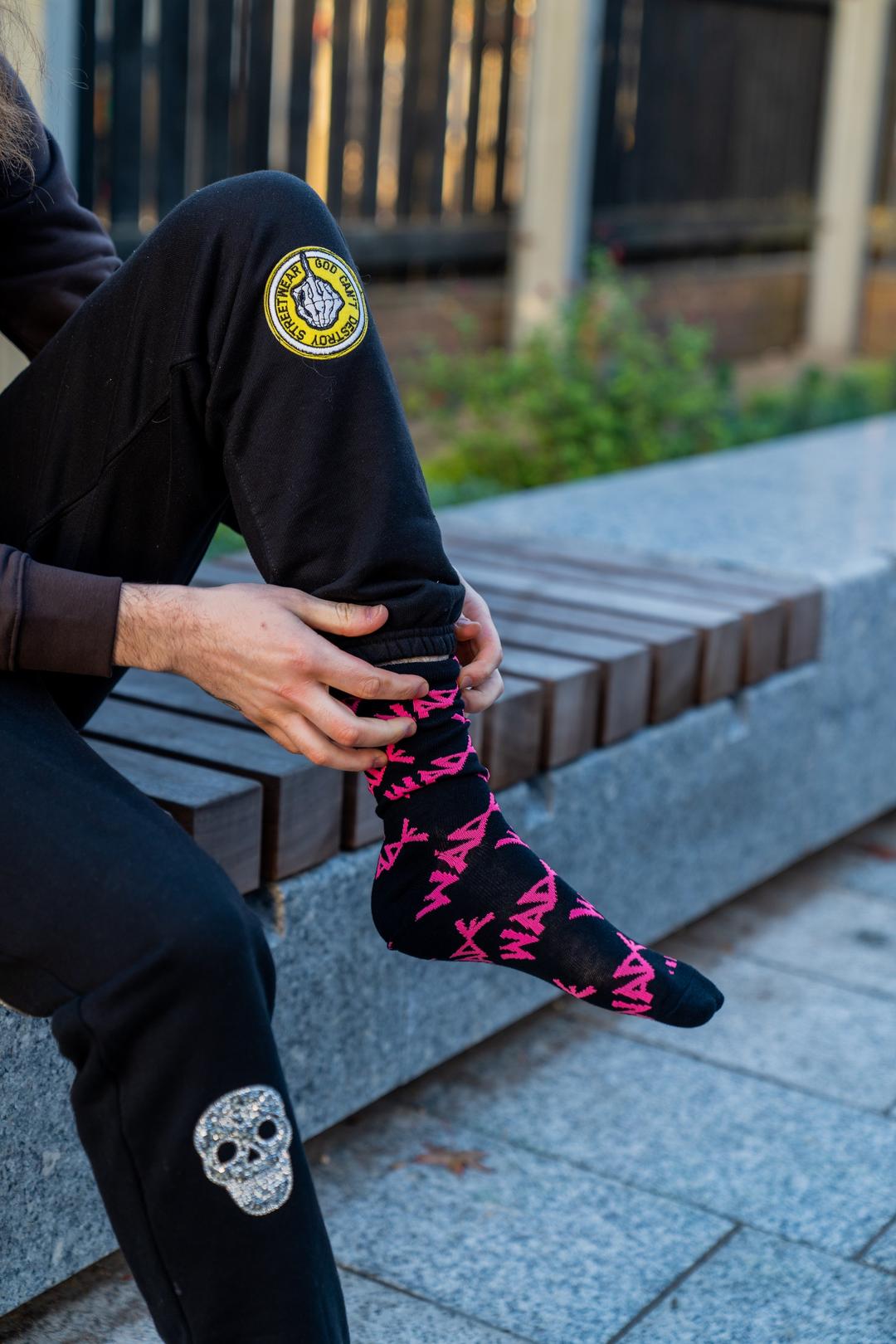 Hands and pink sock logo – London